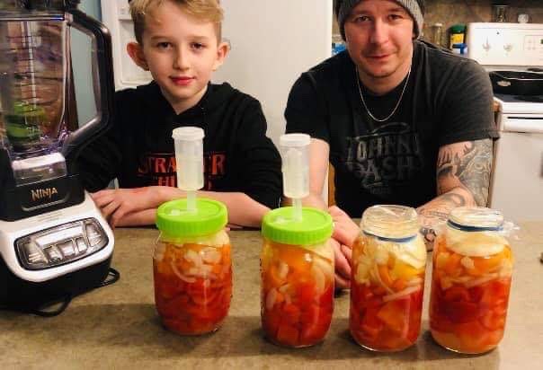 Tony and his son making their first hot sauce